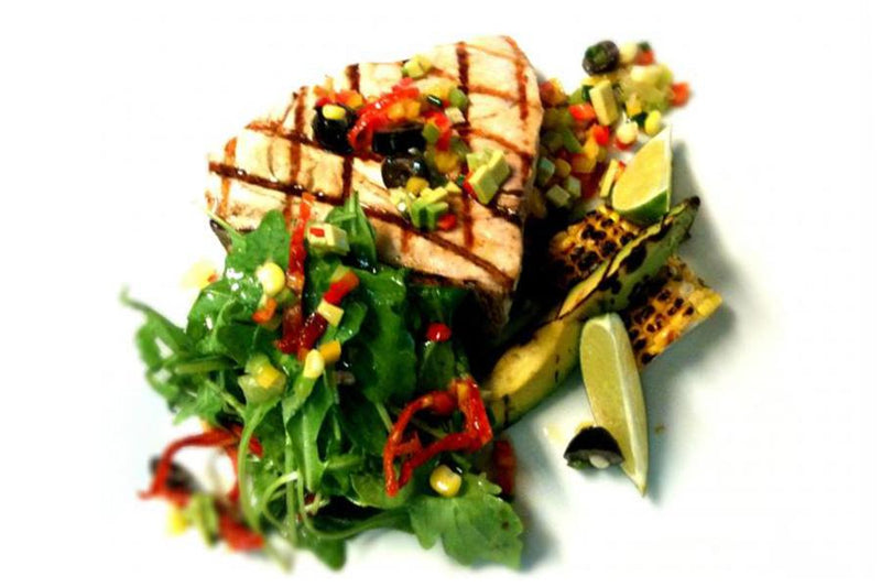 Grilled swordfish and its pepper and avocado salsa with arugula